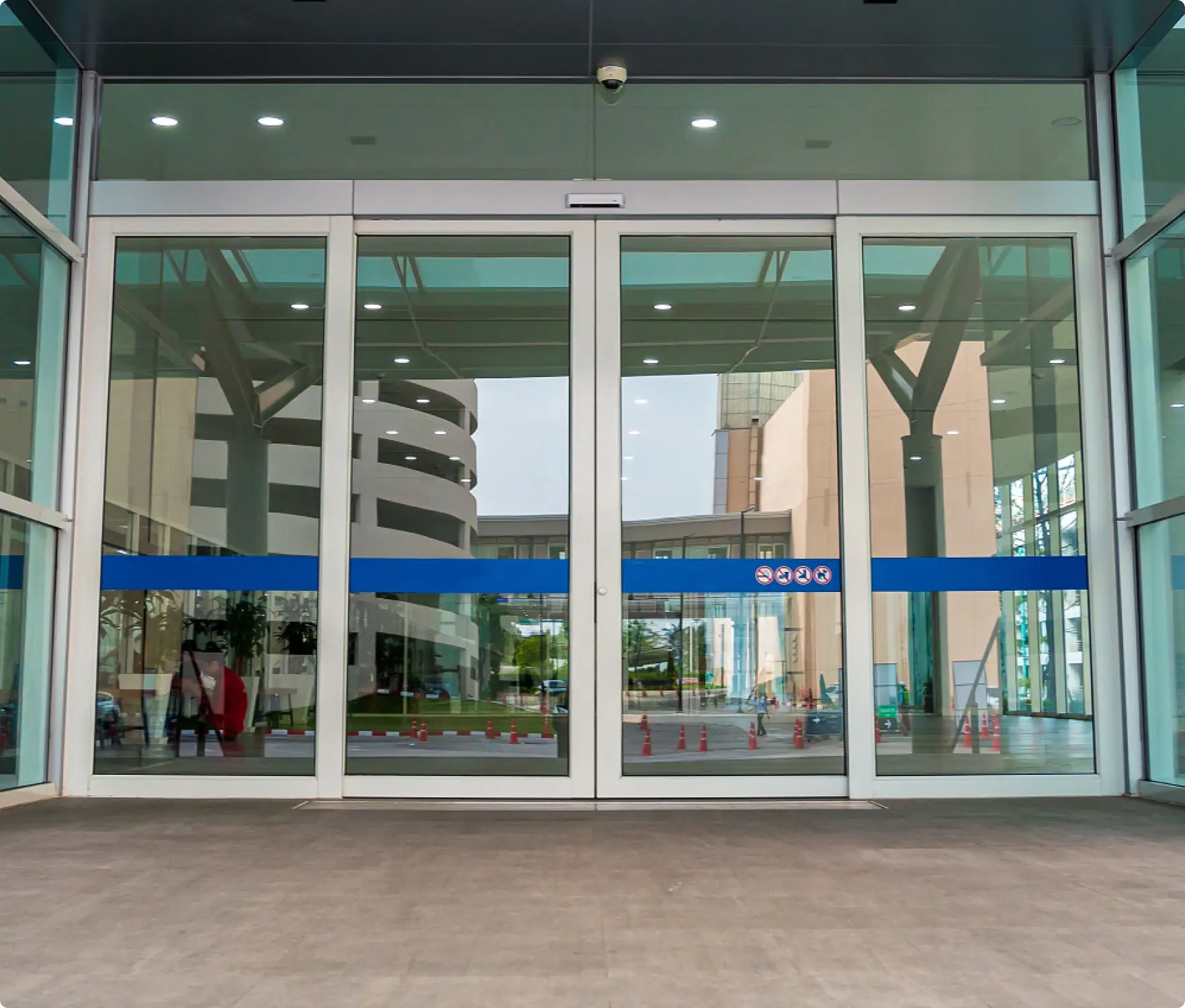 Automatic door safety sensor and access control keypad at a commercial entrance