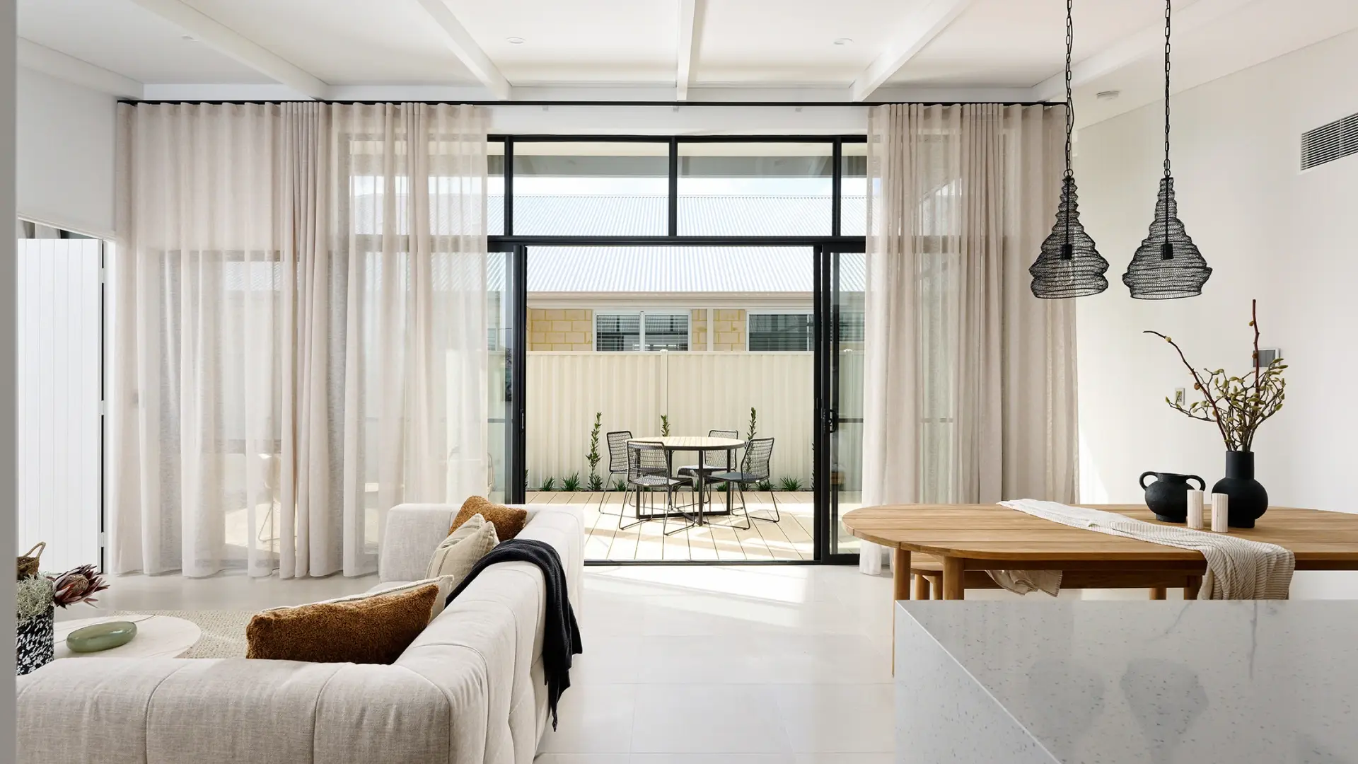 Aluminium stacker doors opening a living space to a timber deck