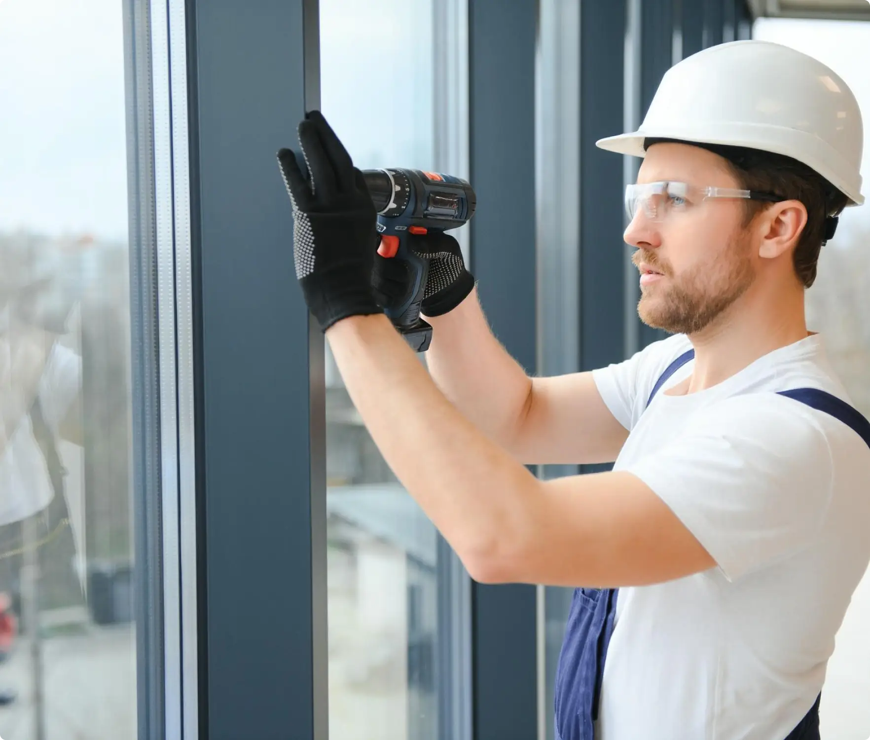 Technician professionally installing commercial automatic sliding doors at a shopfront