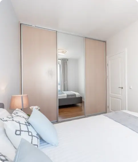 Mirrored sliding wardrobe doors in a bedroom