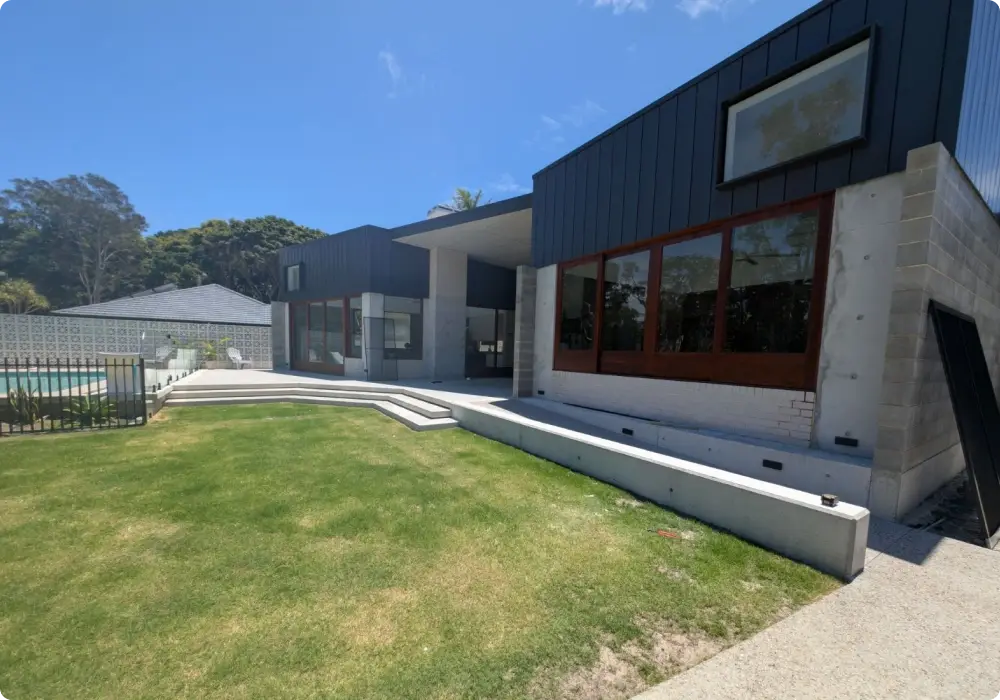 Completed custom aluminium windows installed in a light-filled coastal home