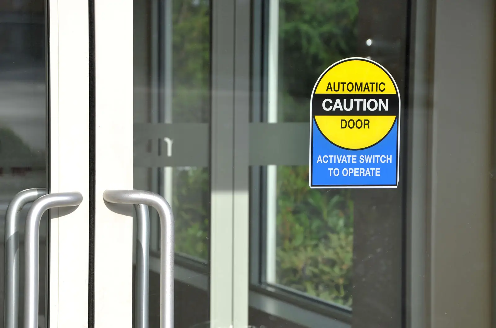 Alumalite technician installing and calibrating a commercial automatic door system
